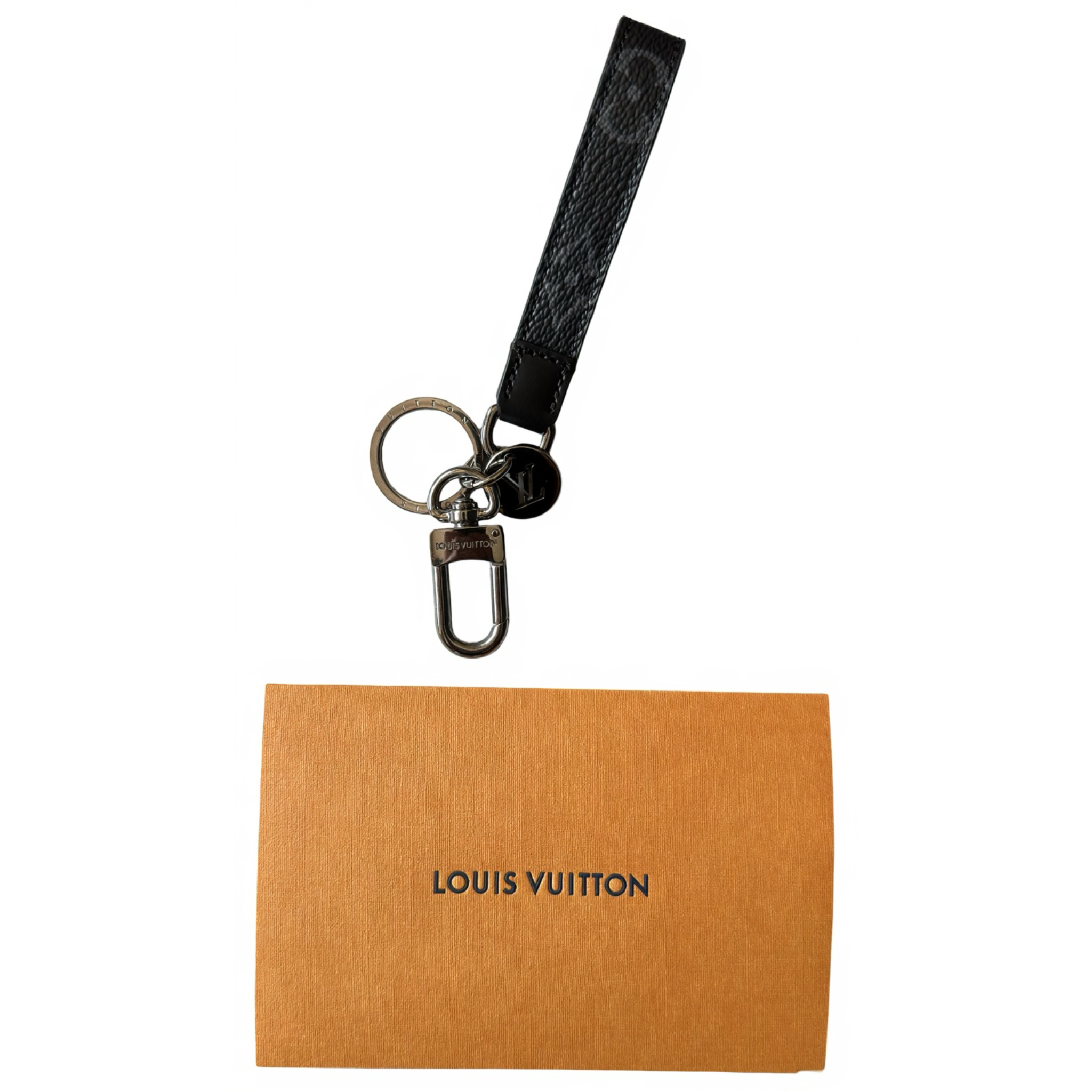 Louis Vuitton keychain with a black strap on an orange card with 'Louis Vuitton' branding.